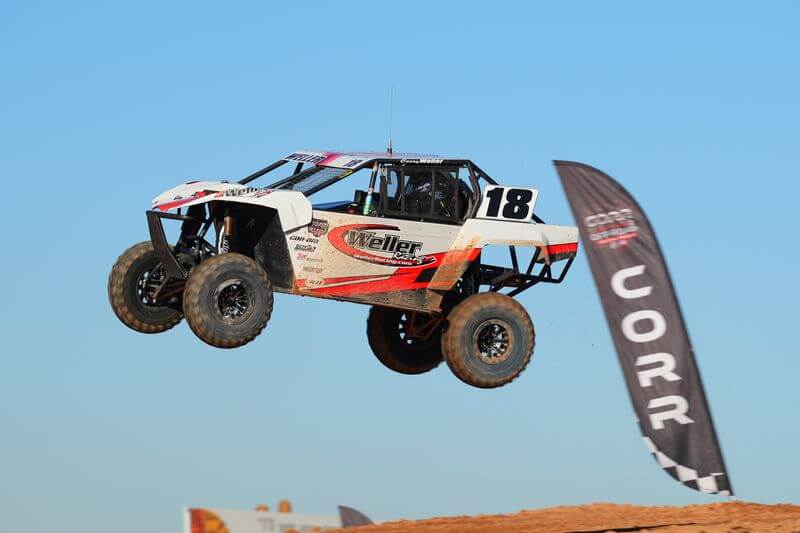 CORR SR1 SxS flying over a jump
